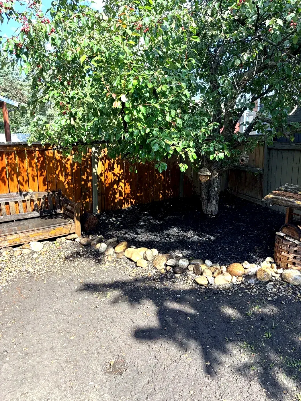 Completed decorative rock and mulch installation in a Calgary yard