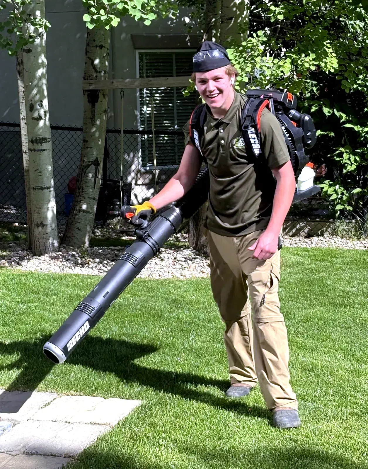 Kavin Alexander, founder of Edge Property Services, with backpack blower on a freshly cut Calgary lawn