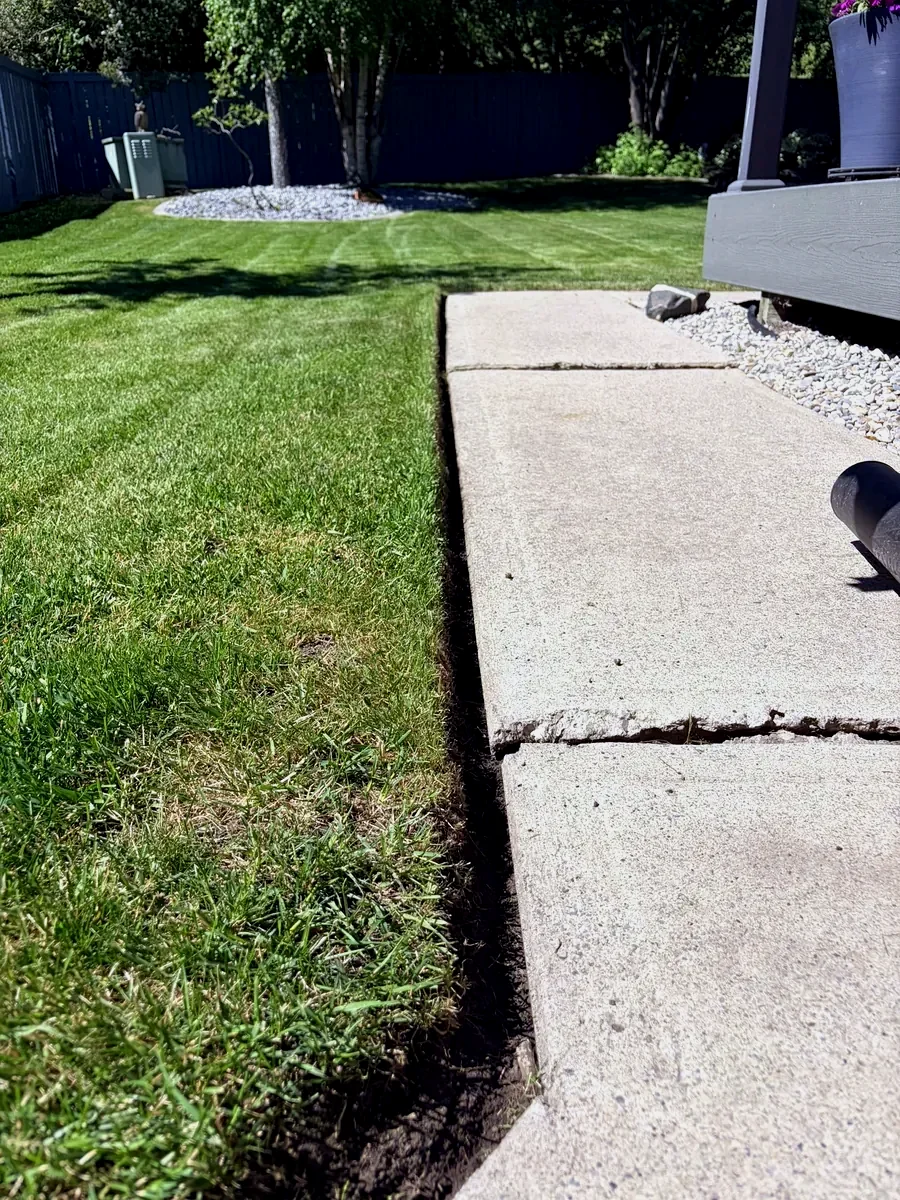 Sharp clean lawn edge along a backyard walkway in Calgary
